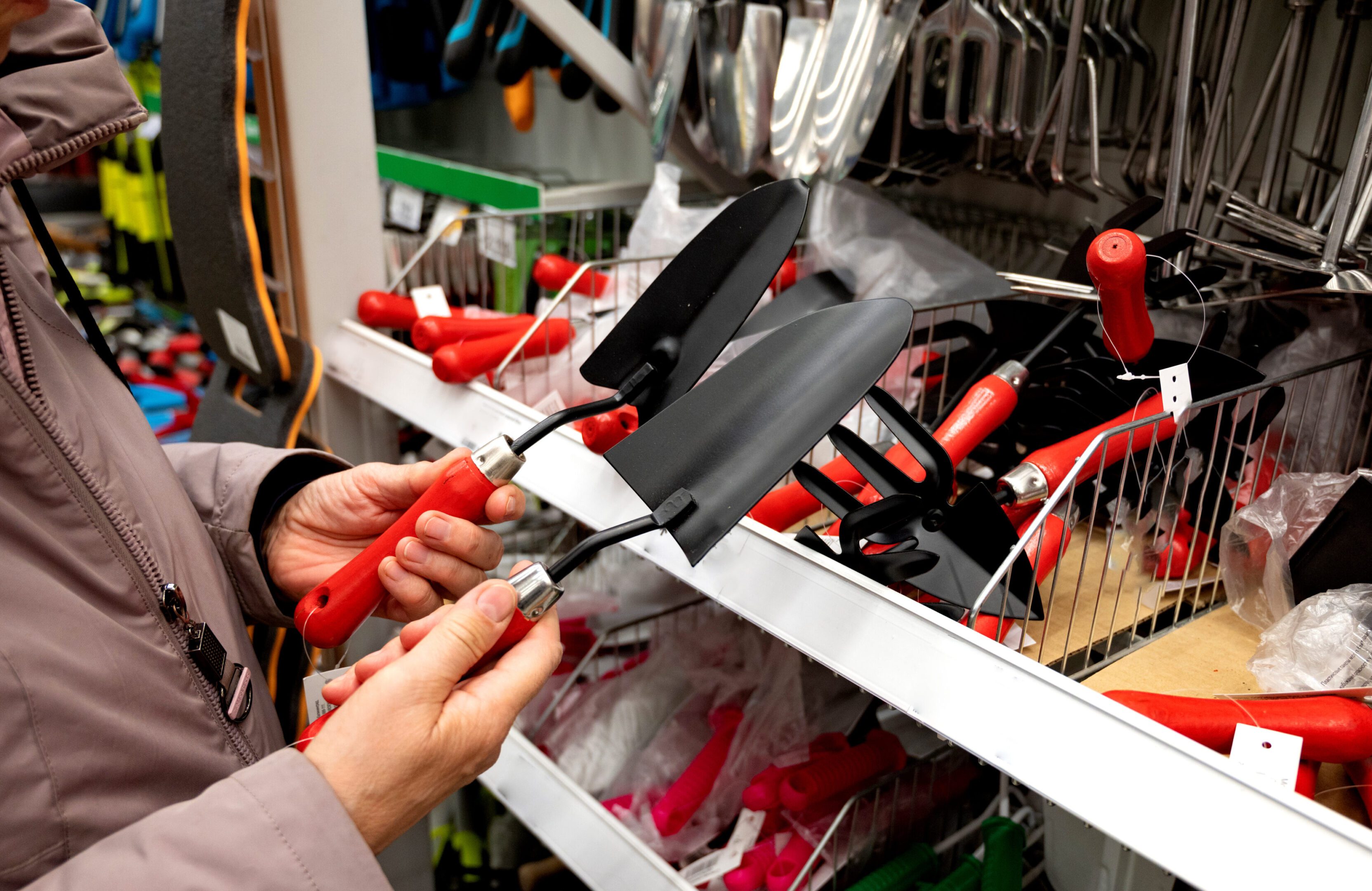 Person cutting a white bicycle cable tie in a bike shop.